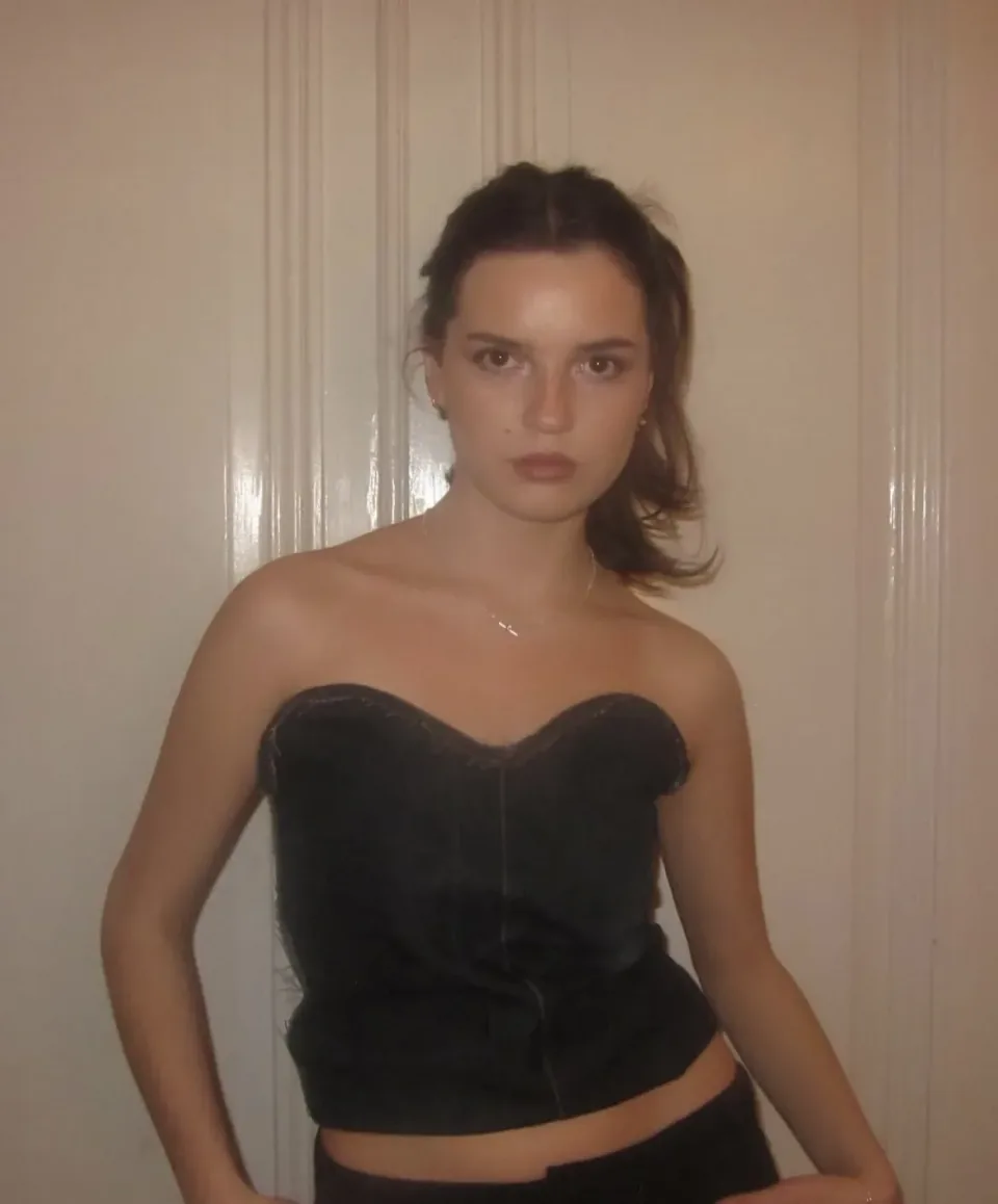 A remade strapless denim corset top with a sweetheart neckline, worn with dark trousers.